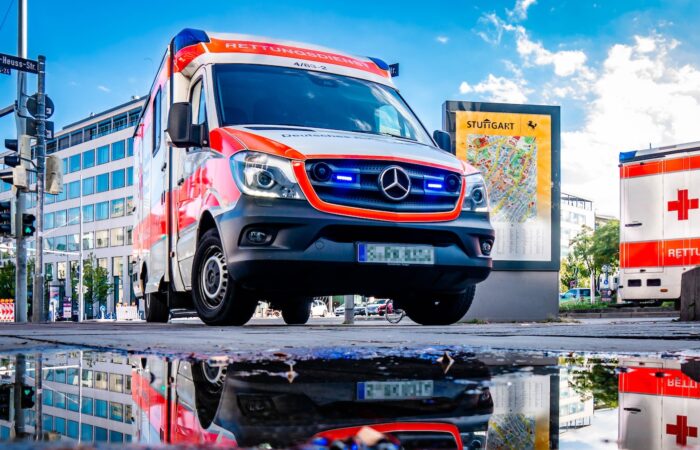 white and red Mercedes-Benz ambulace